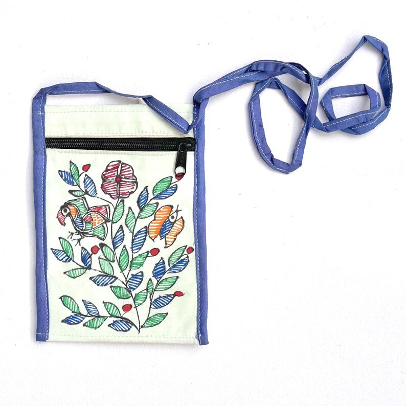 Front view of a mint upcycled cotton zippered pouch with a blue trim extending to form a long blue strap by Store Utsav. The pouch has Madhubani painting done. Its a floral design with green leaves, red flowers, and orange and blue birds. The pouch is a great way to carry your phone, keys, or other small items. Global shipping!