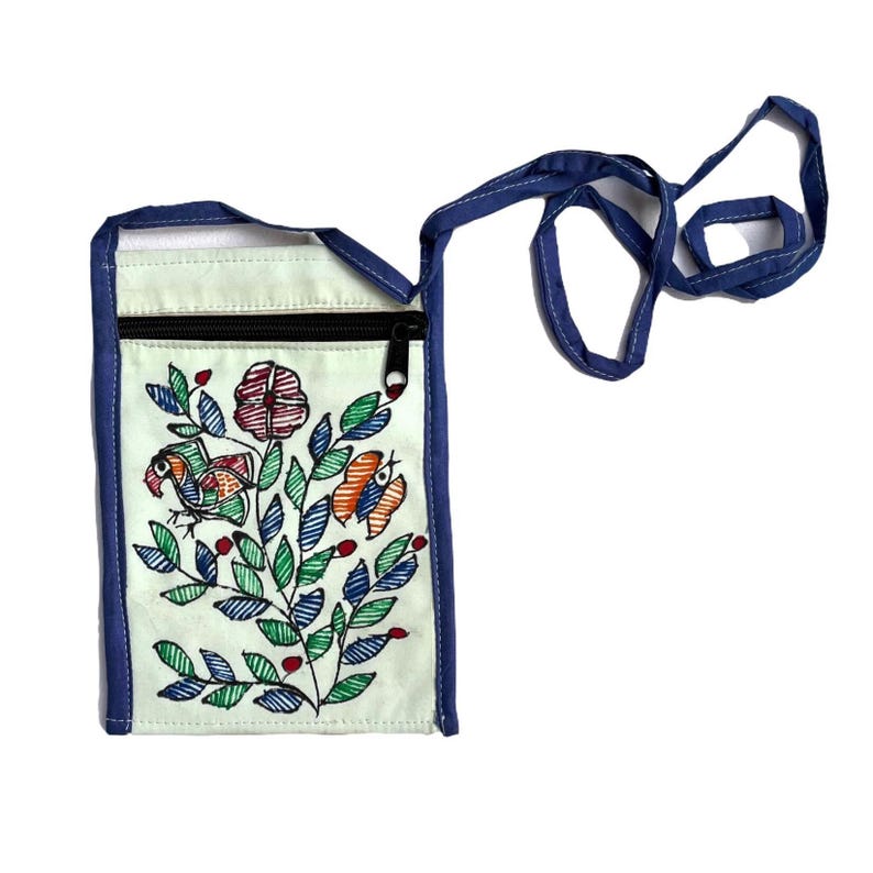 A mint upcycled cotton zippered pouch with a blue trim extending to form a long blue strap. The pouch has Madhubani painting done. Its a floral design with green leaves, red flowers, and orange and blue birds. The pouch is a great way to carry your phone, keys, or other small items.