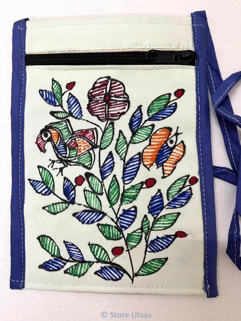May include: A rectangular off-white fabric neck pouch featuring a black zipper closure and blue fabric trim. The front displays a hand-drawn style illustration of a bird, a butterfly, and a floral branch in red, green, and blue ink.