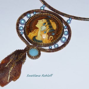 May include: A beaded necklace with a round pendant featuring a painted portrait of a woman with long blonde hair. The pendant is surrounded by blue beads and the necklace is made of brown beads.