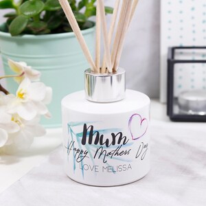 May include: White diffuser bottle with a floral design and the text "Mum Happy Mothers Day Love Melissa".