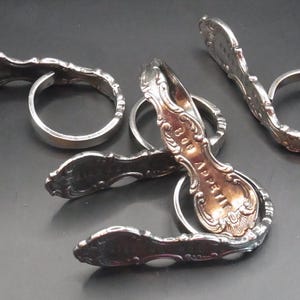 Set of five white metal antique styled napkin rings marked Bon Appetit. Serviette holders. Elegant dining tableware serving. Marriage table