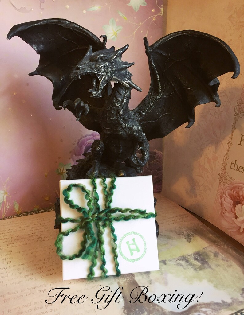 May include: A black dragon statue with outstretched wings stands behind a white gift box tied with green yarn. The box has a green logo and the text "Free Gift Boxing!"