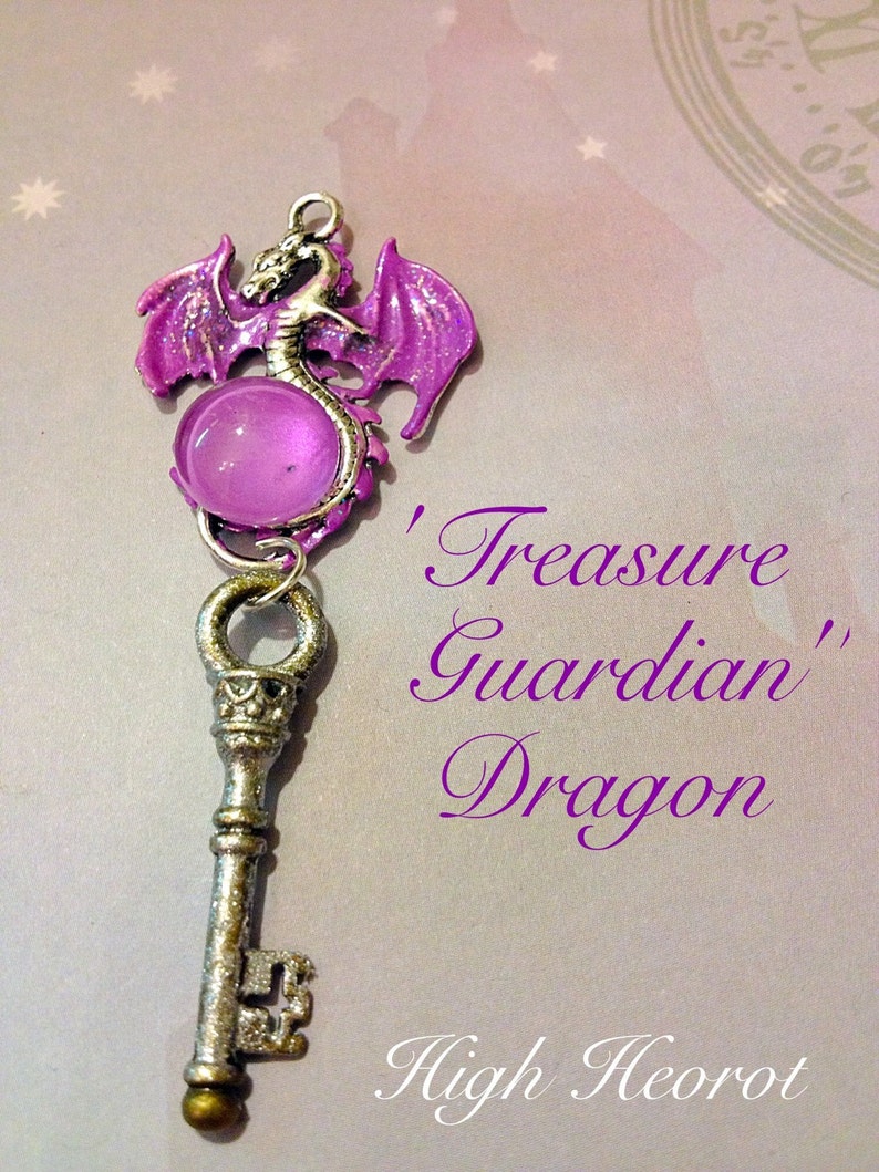 May include: A silver-colored key pendant with a purple dragon charm and a round, translucent purple bead. The dragon has outstretched wings and is attached to the key. The text on the image reads "Treasure Guardian Dragon" and "High Heorot".