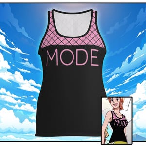 May include: A black vest top featuring a pink grid pattern across the upper chest and shoulder straps. The word MODE is printed in large pink capital letters across the centre of the chest. The garment has a scoop neckline and a sleeveless design.