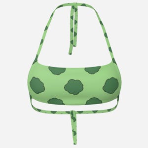 May include: A light green halter top featuring a repeating dark green cloud pattern. The top has tie closures at the neck and back. The fabric is a solid light green with dark green cloud shapes.