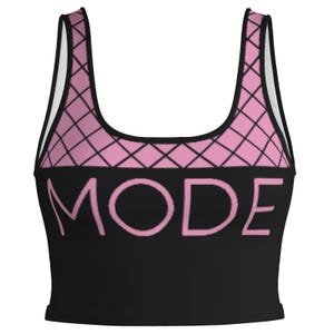 May include: Black crop top featuring a pink diamond pattern across the top and the word "MODE" in pink block letters. The top has a scoop neck and is sleeveless.