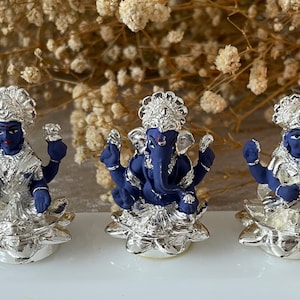 Trinity of Lakshmi Ganesh and Saraswati Figurines Murtis on a white pedestal Diwali Pooja Dhanteras Available in four finishes