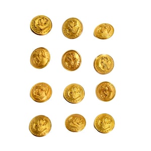 May include: A collection of twelve gold-colored buttons. Each button features a detailed embossed design of an eagle with outstretched wings, surrounded by stars. The buttons are round and have a shiny finish.