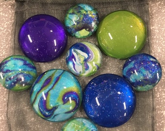 Glass fridge magnets set in blue green and purple, solid and marbled. Both 1 inch round magnets and half inch round  refrigerator magnets