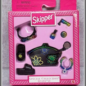 May include: A Skipper Special Collection Teen Stuff set in a pink box. The set includes a black purse with floral designs, a black bracelet, a beaded necklace with a flower charm, two black shoes, a small bottle, a circular token, and a tool.