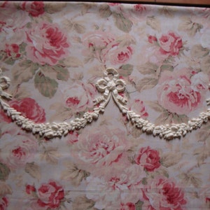 May include: White decorative trim with a floral design and bows. The trim is made of a lightweight material and is perfect for adding a touch of elegance to any home decor project.