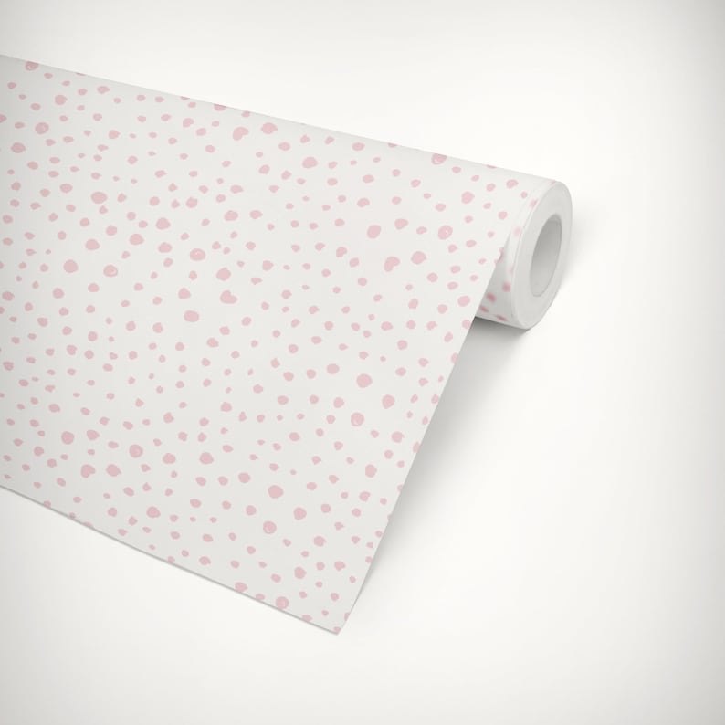 May include: A roll of white wallpaper with a pink polka dot pattern. The wallpaper is rolled up and the end of the roll is visible.
