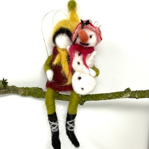 Wool needle felted boy with his snowman friend hanging Christmas ornaments