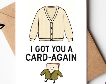 May include: A white greeting card with a beige cardigan illustration and the text "I GOT YOU A CARD-AGAIN". The card is on a brown envelope, with the words "Download and Print" at the top. A purple circle with "Digital Card" is in the corner.