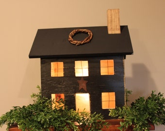 Wooden primitive house with low wattage bulb for ilumination