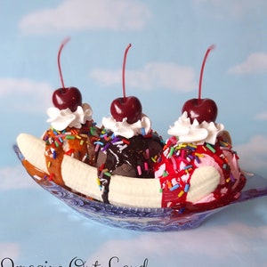 May include: A banana split with three scoops of ice cream, topped with whipped cream, cherries, chocolate sauce, caramel sauce, and sprinkles, served in a blue and white banana split dish.