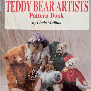 May include: A book titled American Teddy Bear Artists Pattern Book by Linda Mullins. The cover features a group of six plush teddy bears of various sizes, colors, and outfits, including one wearing a purple hat and another in a red jacket.