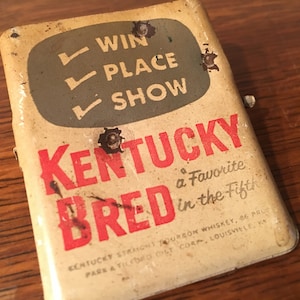 Kentucky Bred Whiskey Advertising clip with bullet holes
