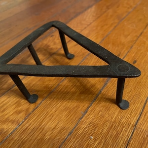 Antique geometric wrought-iron triangular trivet