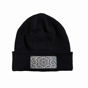 May include: Black knit beanie with a white geometric design patch on the front.