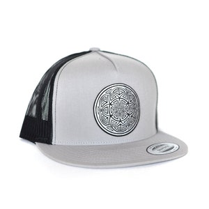 May include: A grey and black trucker hat with a black and white geometric design on the front.