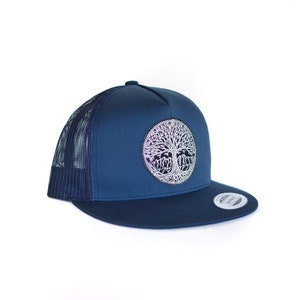May include: A navy blue trucker hat with a black and white tree of life design on the front.