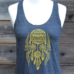 May include: A dark gray tank top with a gold dreamcatcher design. The dreamcatcher has a geometric pattern and feathers.