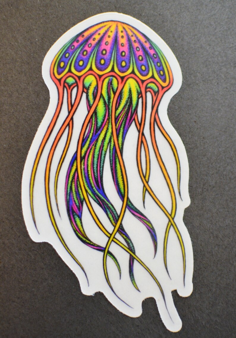 K&ouml;nnte beinhalten: Ein bunter Quallenaufkleber mit einem regenbogenfarbenen K&ouml;rper und Tentakeln. Die Qualle hat eine lila und gelbe Kuppel mit einem Muster aus kleinen Kreisen.