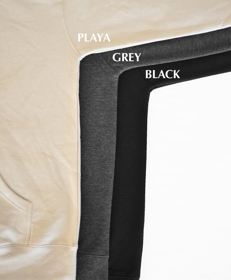 May include: Close-up of three hoodies in Playa, Grey, and Black. The Playa hoodie is a light beige color, the Grey hoodie is a medium gray, and the Black hoodie is a solid black. The names of the colors are printed on the image.