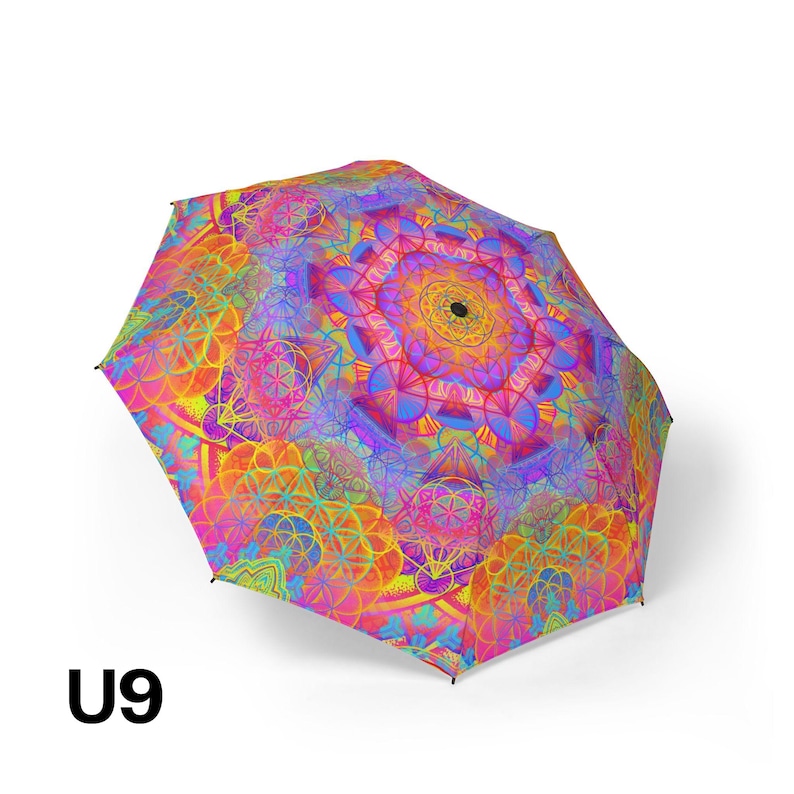 May include: A collapsible umbrella featuring a vibrant, multi-colored geometric pattern with overlapping circular mandala designs in shades of hot pink, orange, yellow, and blue. The canopy displays a repeating sacred geometry motif and the text U9.