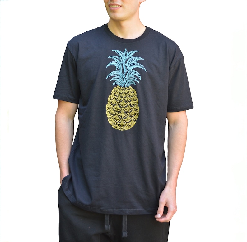 May include: A black t-shirt with a blue and yellow pineapple graphic.
