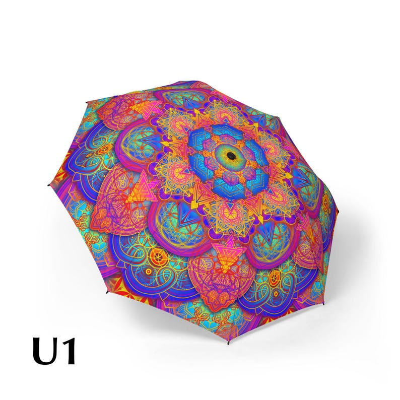 May include: A collapsible umbrella featuring a vibrant, multi-colored mandala pattern with intricate geometric shapes in shades of blue, purple, pink, orange, and yellow. The design radiates from a central point, and the text U1 is visible.