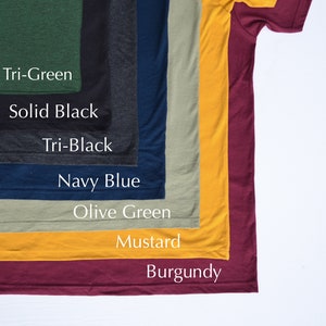 May include: A selection of t-shirts in various colors, including tri-green, solid black, tri-black, navy blue, olive green, mustard, and burgundy.
