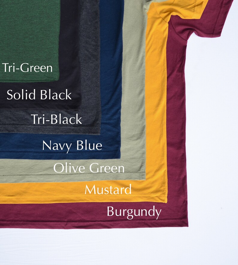 May include: A selection of t-shirts in various colors, including tri-green, solid black, tri-black, navy blue, olive green, mustard, and burgundy.
