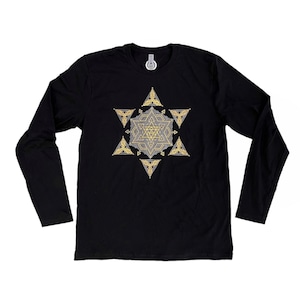 May include: Black long-sleeve shirt featuring a detailed geometric design in gold and gray. The design is a star shape with intricate patterns. The shirt is made of a soft material and has a crew neck.