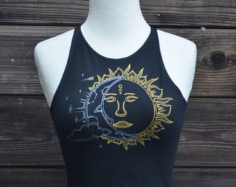 May include: Black tank top with a gold and silver sun and moon design. The sun has a face and the moon is crescent shaped.