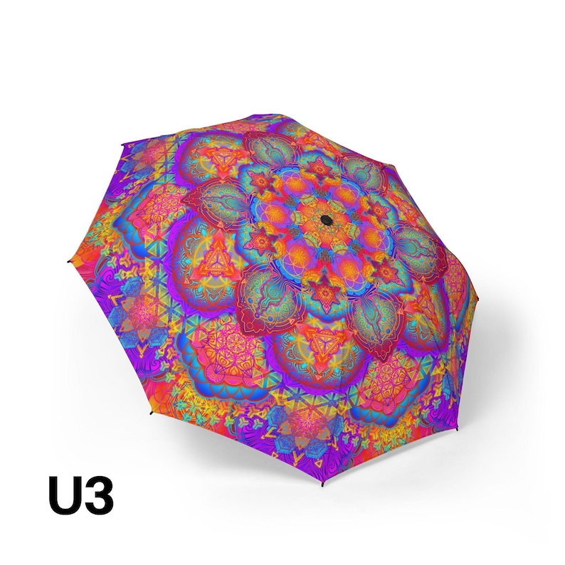 May include: A collapsible umbrella featuring a vibrant, multi-colored mandala pattern. The design incorporates intricate geometric shapes and floral-like motifs in shades of bright purple, neon orange, electric blue, and hot pink. The text U3 is visible.