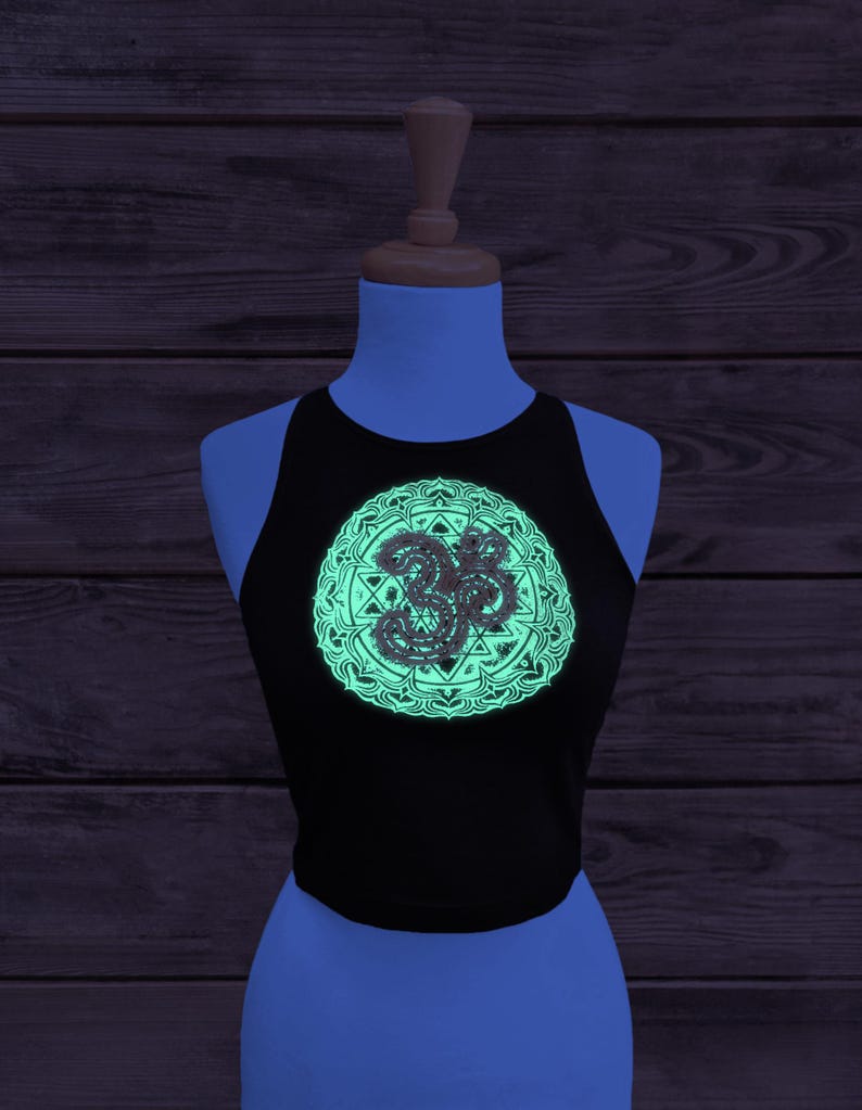 Glow in the dark Sri Yantra crop top. Image taken under UV light to show the glow in the dark layer how it could appear for music festivals or events!