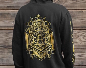 May include: A black hooded sweatshirt featuring a gold-colored geometric bee graphic on the back and hood. The design incorporates hexagonal patterns and intricate line work. A matching gold bee and honeycomb print is visible on the sleeve.