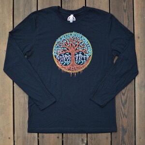 May include: Black long-sleeve t-shirt with a colorful tree of life design. The tree has a red trunk, blue and green leaves, and yellow accents.