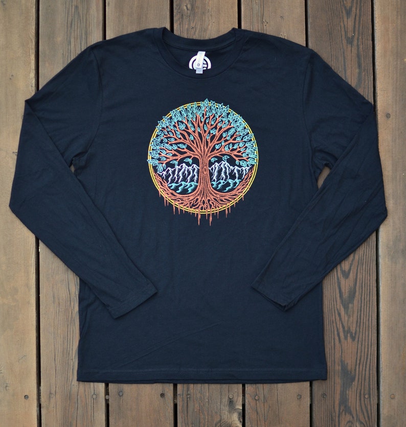 May include: Black long-sleeve t-shirt with a colorful tree of life design. The tree has a red trunk, blue and green leaves, and yellow accents.