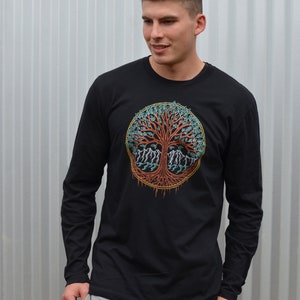 May include: A black long-sleeve shirt with a colorful tree of life design on the front. The tree has a red trunk, green leaves, and blue roots.