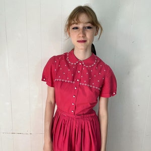 Late #50s embroidered dark pink number by “Vicky Vaughn”