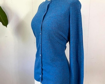 May include: A blue cardigan sweater with a button-up front and long sleeves.