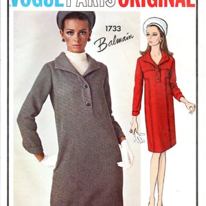 May include: Vogue Paris Original pattern 1733 Balmain. Two women's dress patterns, one in red and one in gray. The red dress is short and sleeveless. The gray dress is long-sleeved and has a collar.