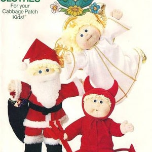 May include: Vintage Cabbage Patch Kids clothing pattern featuring three dolls dressed as Santa Claus, an angel, and a devil. The Santa doll has a red suit and a black bag. The angel doll is in a white robe. The devil doll is in a red suit.