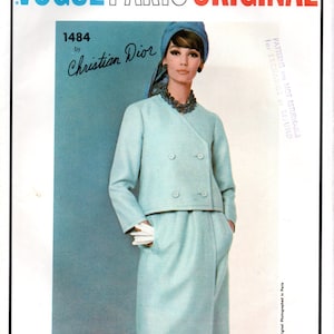 May include: A vintage Vogue Paris Original sewing pattern featuring a design by Christian Dior. The pattern number is 1484. The model is wearing a light blue double-breasted jacket and skirt suit with a matching light blue hat.