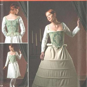 May include: Simplicity pattern 2621 features a historical costume. The design includes a green and white bodice with a matching skirt. The image shows a woman wearing the costume, with additional views of the design.