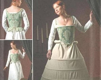 May include: Simplicity pattern 2621 features a historical costume. The design includes a green and white bodice with a matching skirt. The image shows a woman wearing the costume, with additional views of the design.